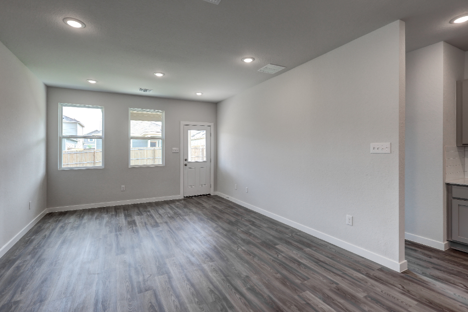 A room with a wood floor and white walls.