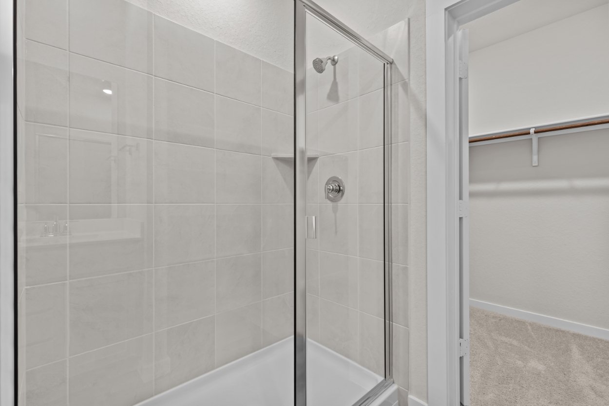 A shower with a glass door.