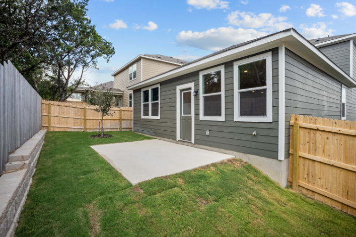 A house with a fence and yard.