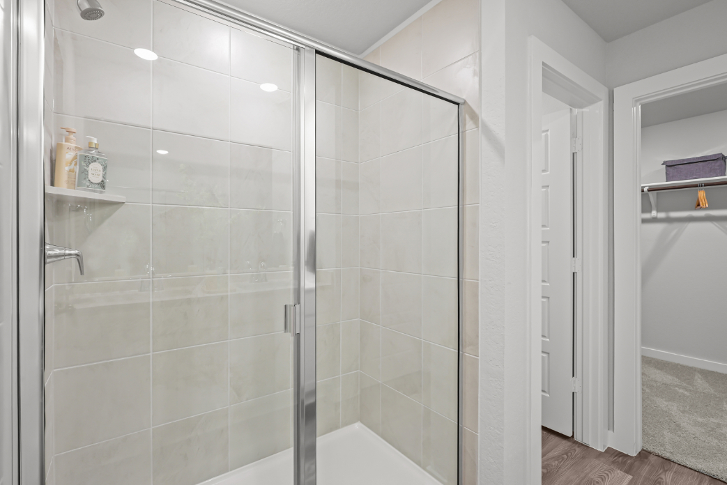 A shower with a glass door.