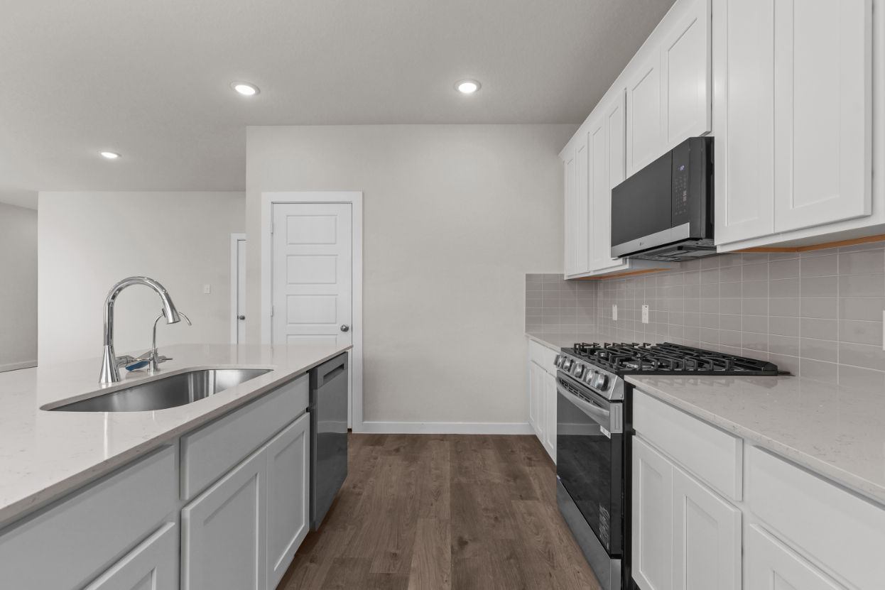 A kitchen with white cabinets.
