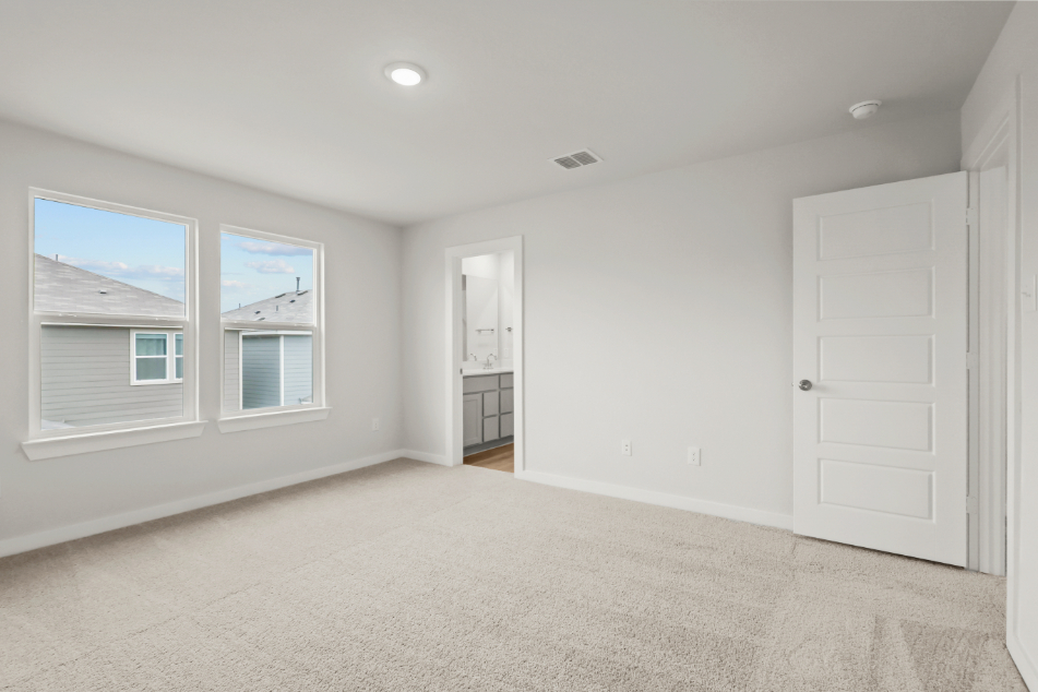 A room with white walls and a window.