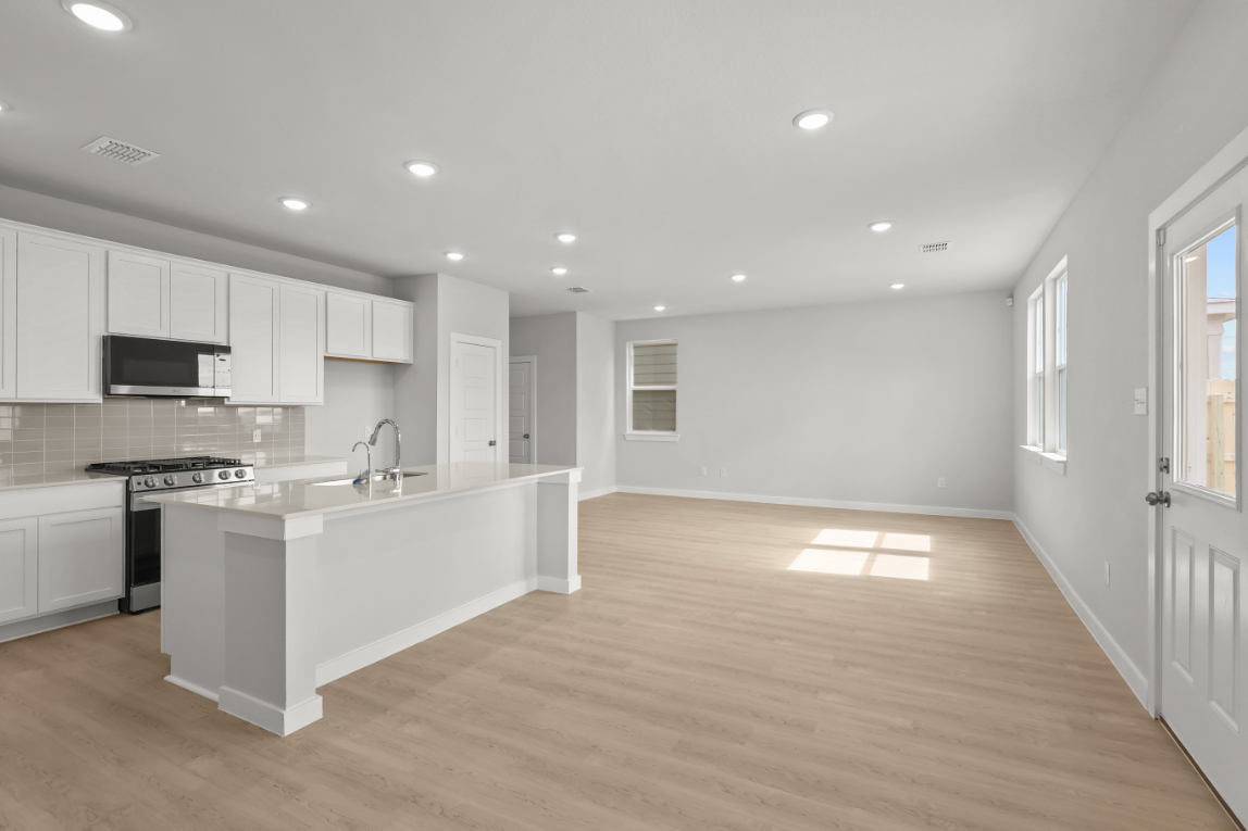 A kitchen with white cabinets.