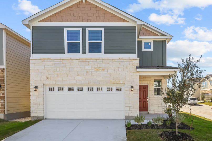 A white house with a garage.