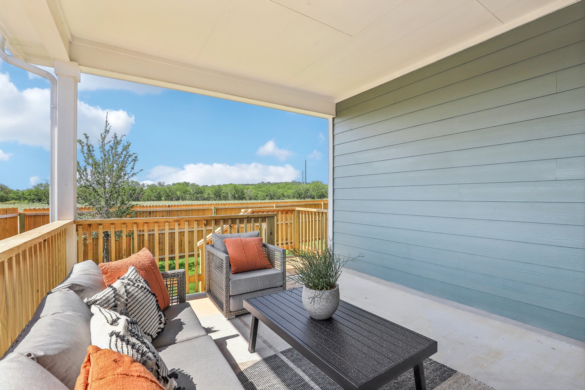 A patio with a table and chairs.
