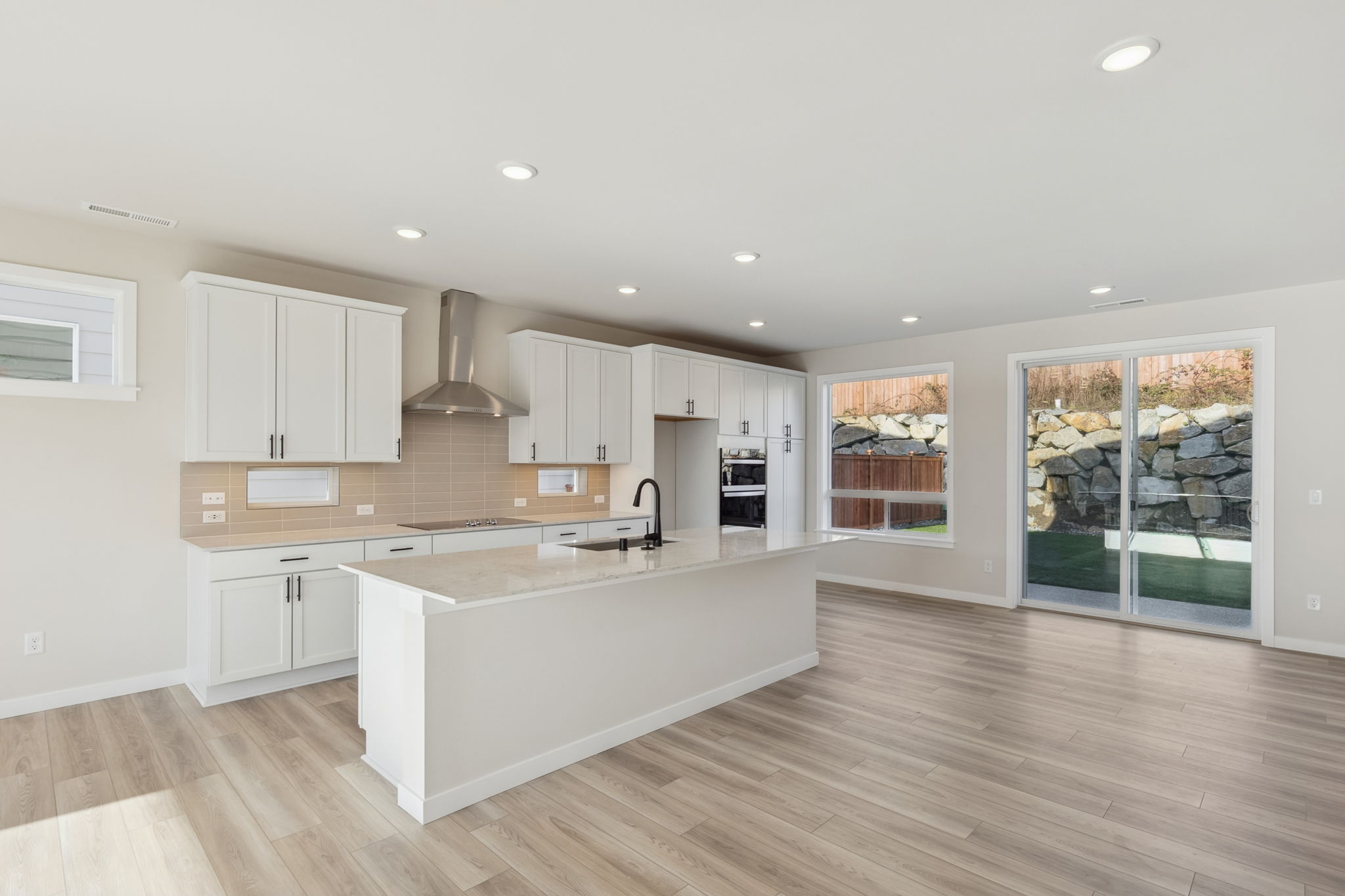 A kitchen with white cabinets.