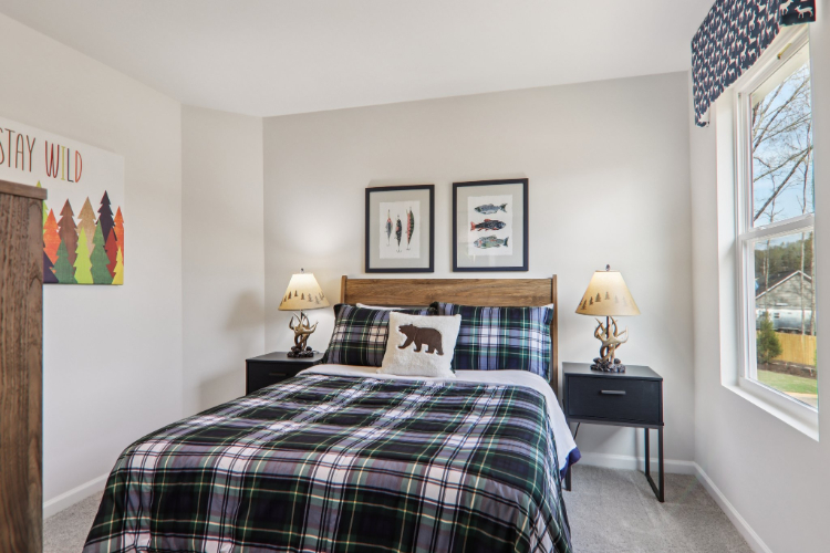 A bedroom with a bed and lamps.