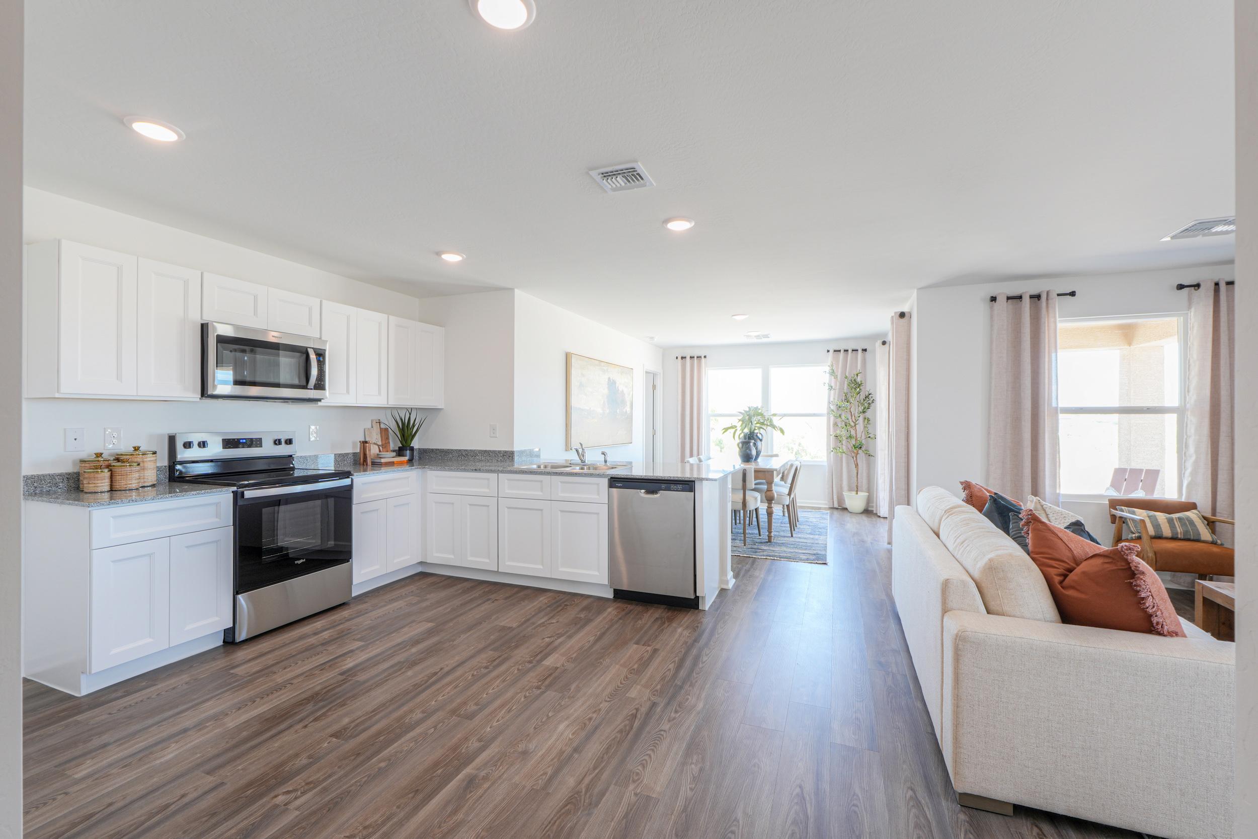 A large kitchen with white cabinets.