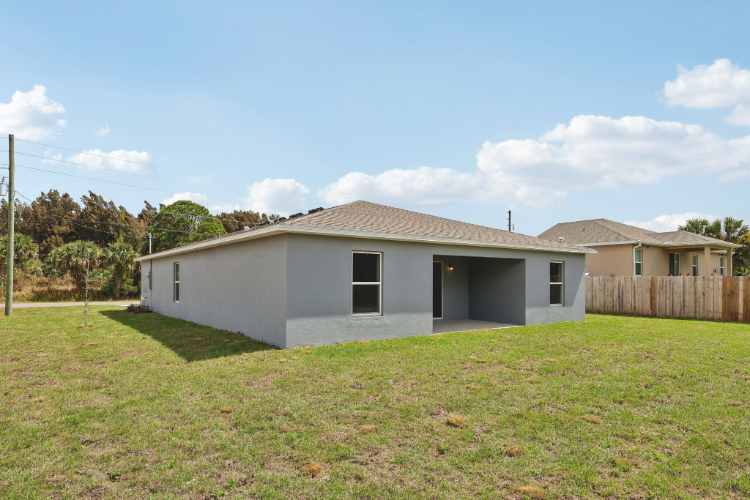 A white house with a fence.
