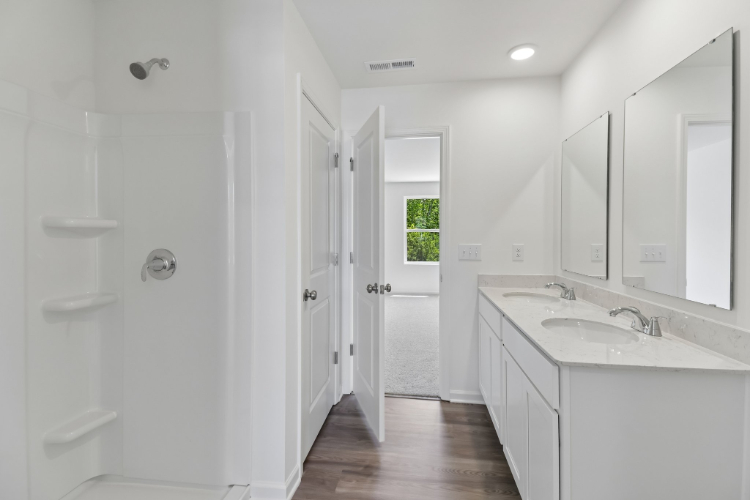 A bathroom with white cabinets.