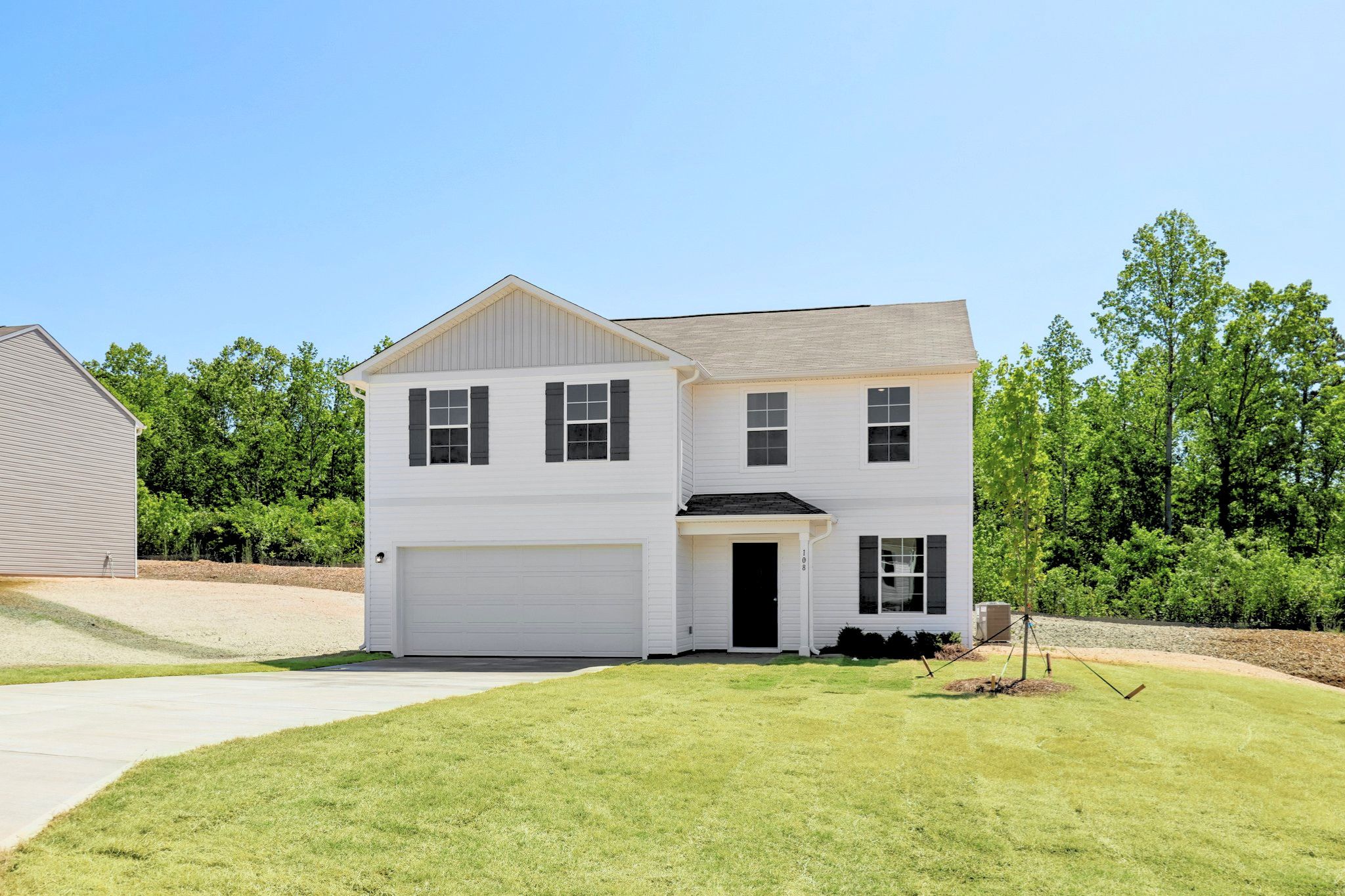 A white house with a garage.