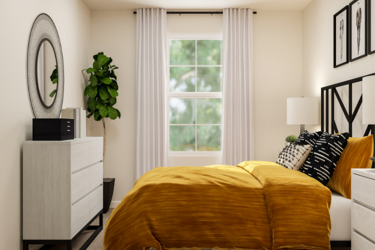 A bedroom with a bed and a mirror.